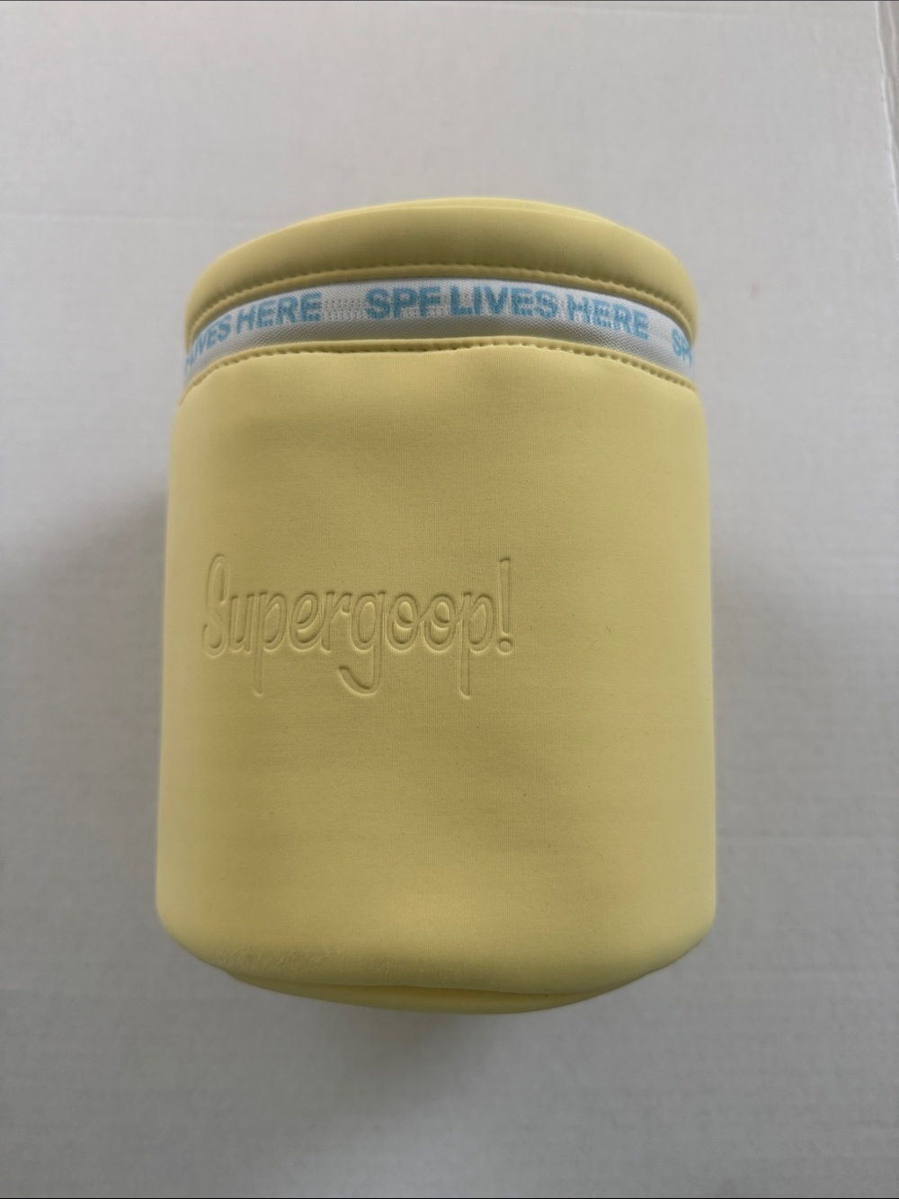 Supergoop! Pale Yellow Neoprene Sunscreen Pouch with Blue Accent - Picture 1 of 5